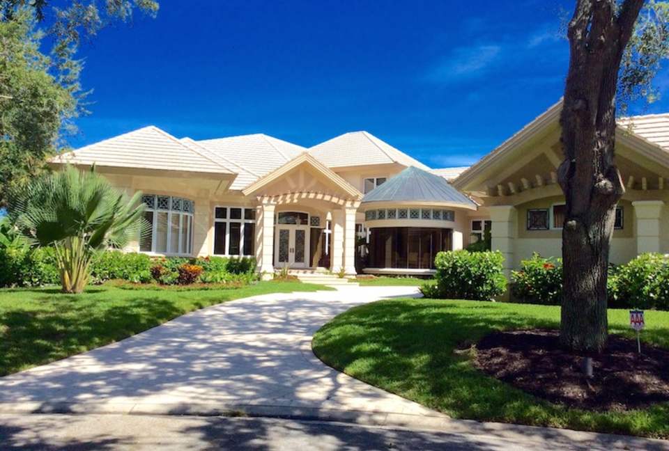 Bonita Bay Estate Home with glass walled dining room overlooking 10,000 gallon pond. - Bonita Springs, Florida