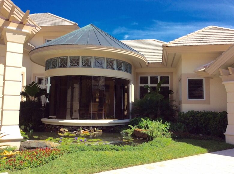 Bonita Bay Estate Home with glass walled dining room overlooking 10,000 gallon pond. - Bonita Springs, Florida