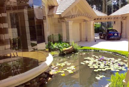 Bonita Bay Estate Home with glass walled dining room overlooking 10,000 gallon pond. - Bonita Springs, Florida