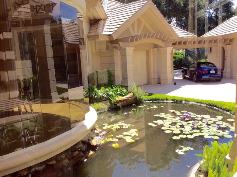 Bonita Bay Estate Home with glass walled dining room overlooking 10,000 gallon pond. - Bonita Springs, Florida