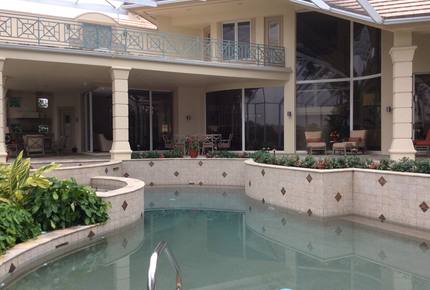 Bonita Bay Estate Home with glass walled dining room overlooking 10,000 gallon pond. - Bonita Springs, Florida