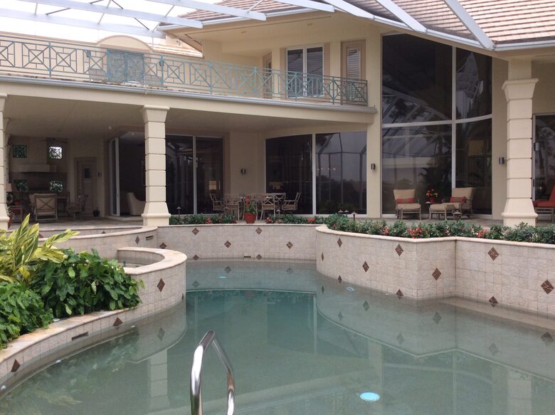 Bonita Bay Estate Home with glass walled dining room overlooking 10,000 gallon pond. - Bonita Springs, Florida