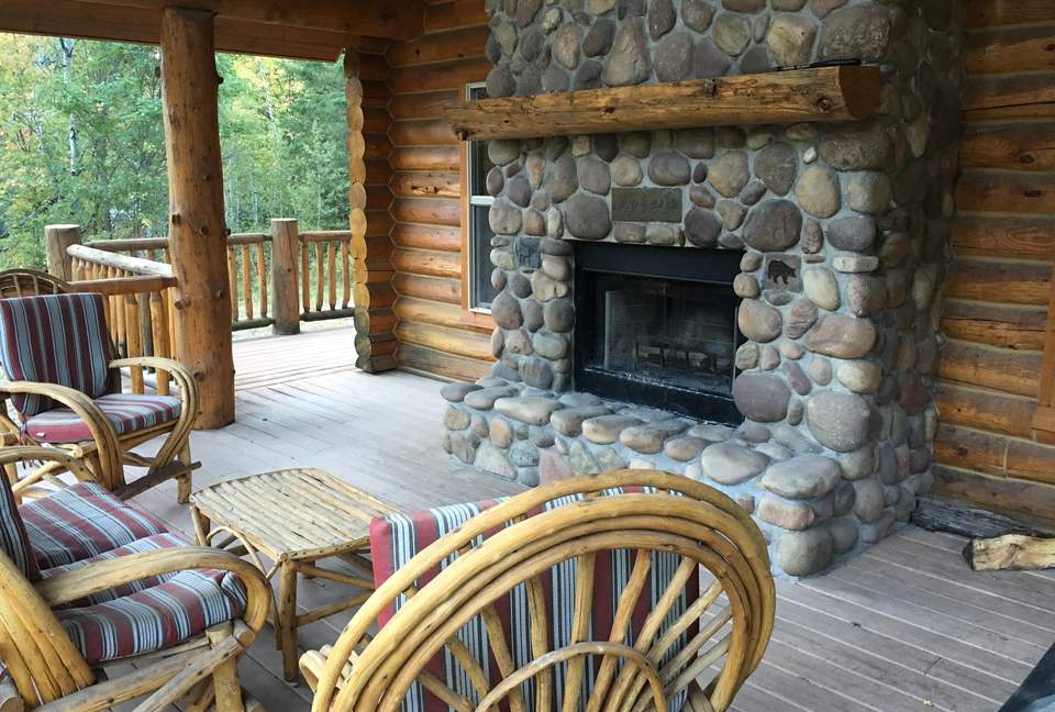 Back deck with river rock, wood burning fireplace