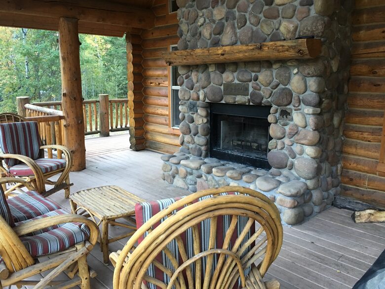 Back deck with river rock, wood burning fireplace