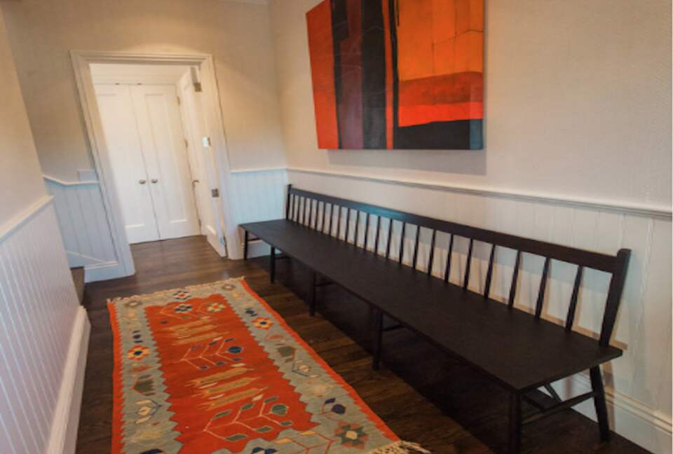 The hallway with art adjoining the guest bedrooms.