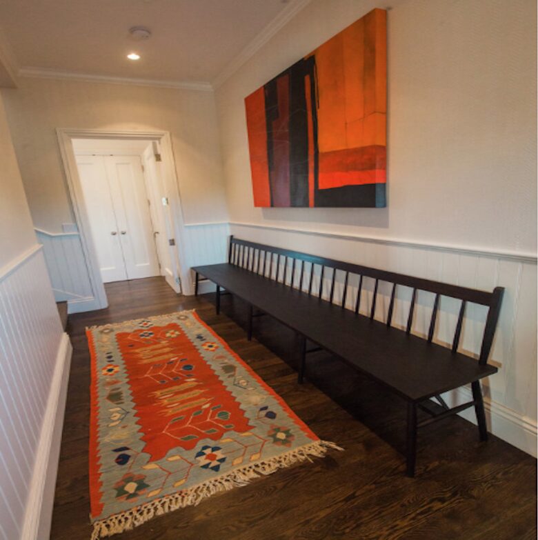 The hallway with art adjoining the guest bedrooms.