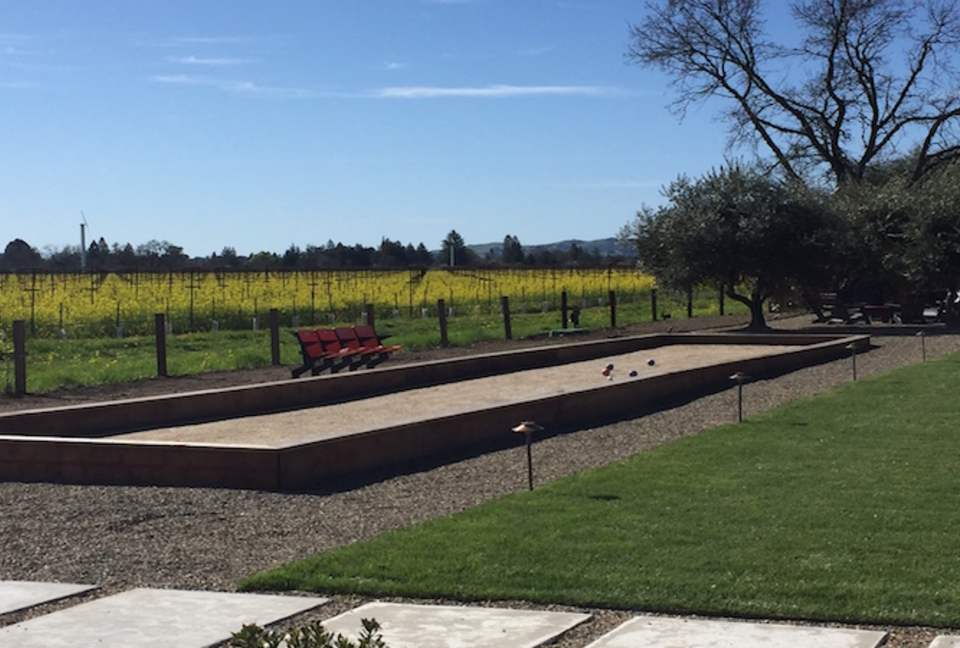The bocce ball court looking upon blooming mustard.