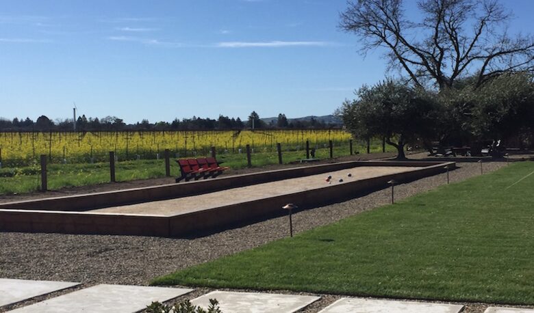 The bocce ball court looking upon blooming mustard.