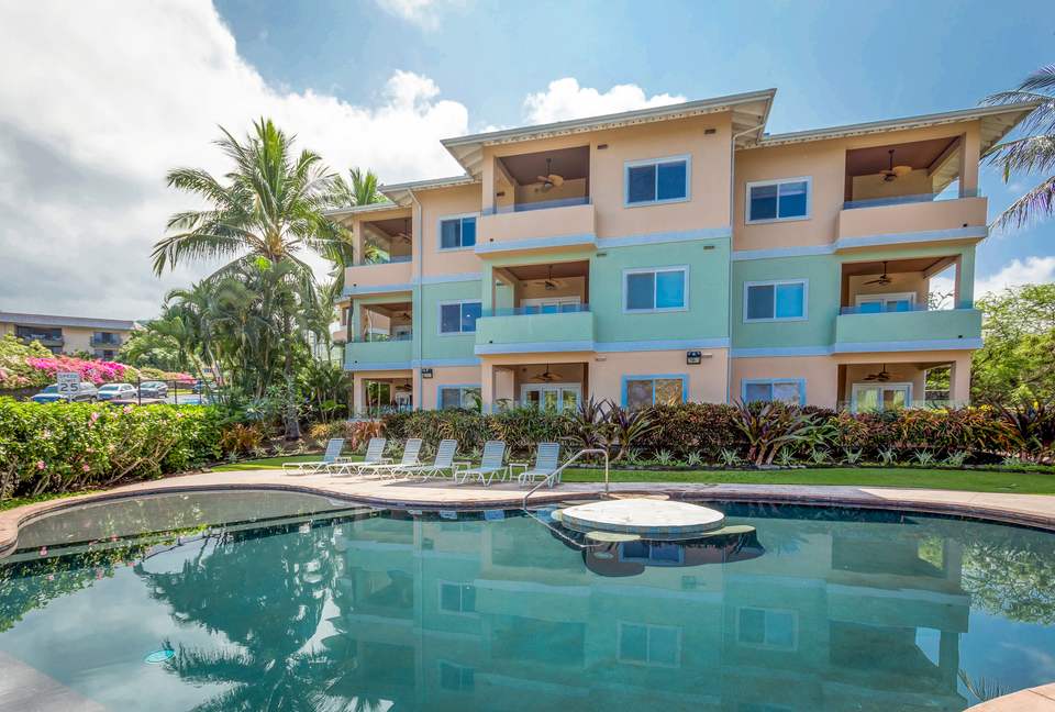Beach condo exterior with pool and spa
