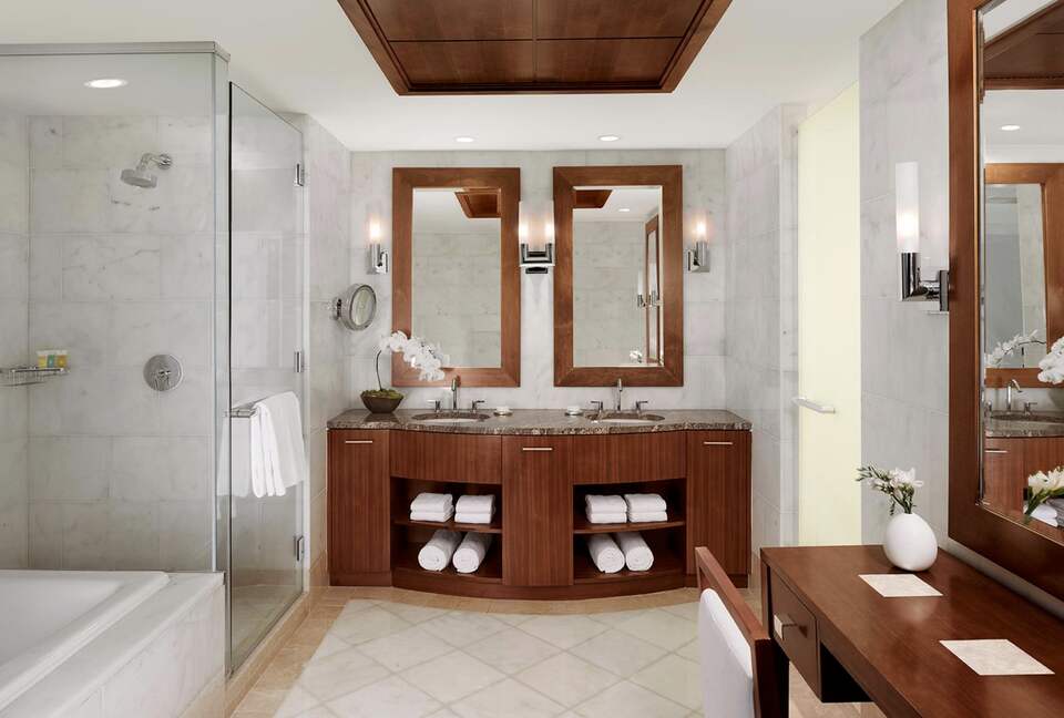 Spacious bathroom with separate tub and glass shower