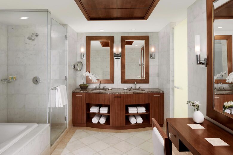 Spacious bathroom with separate tub and glass shower