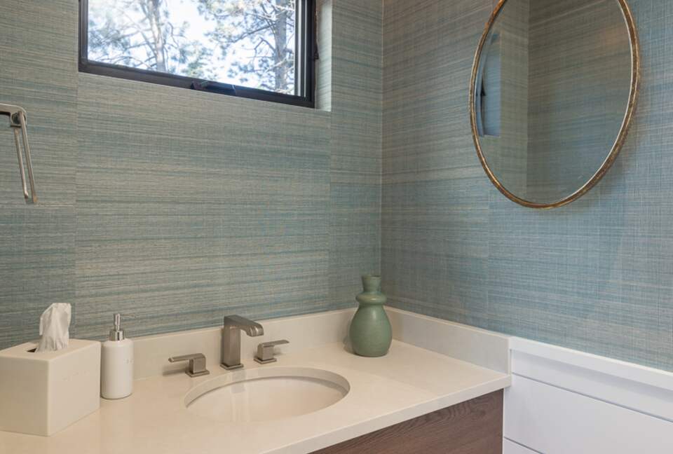 Main floor family room bathroom sink with window above.