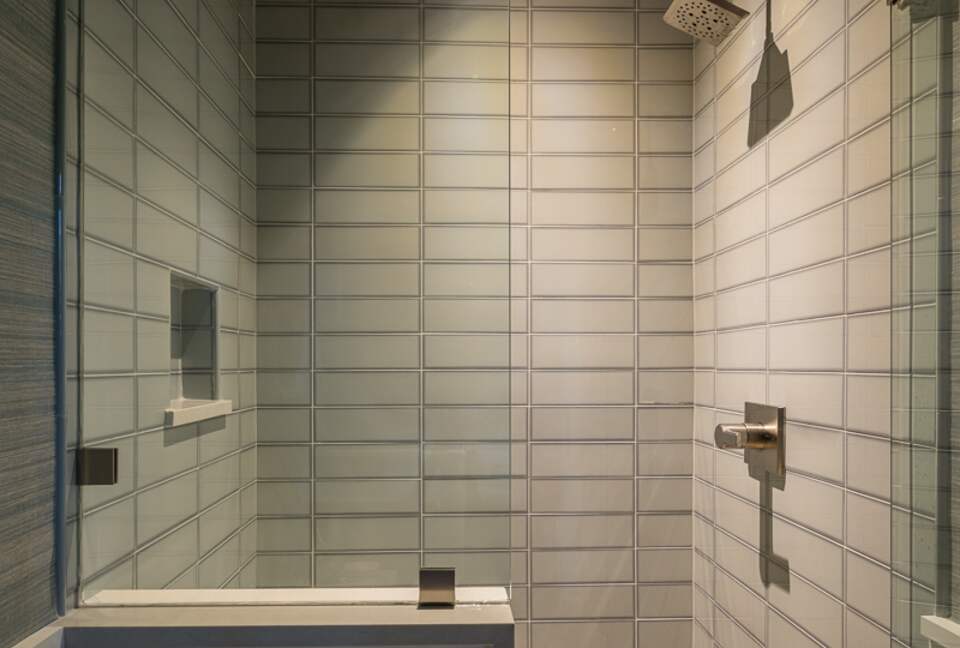 Main floor family room glass-enclosed walk-in shower.