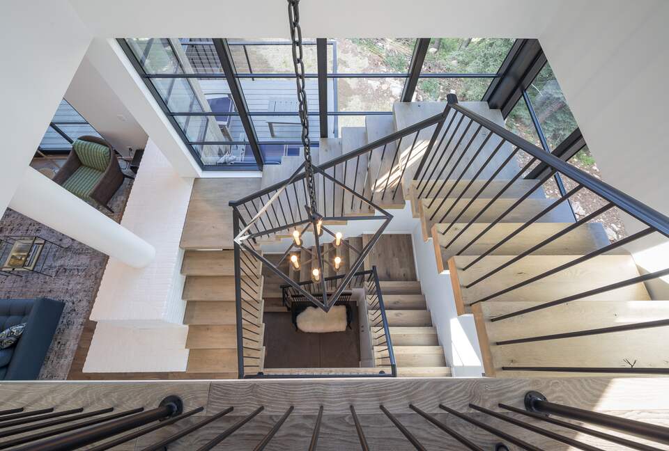 View from second floor stairs looking down to bottom floor.