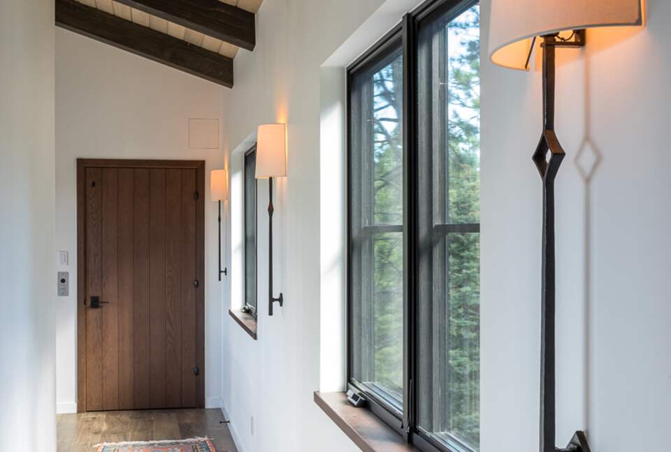 Upstairs hallway with windows and elevator door.