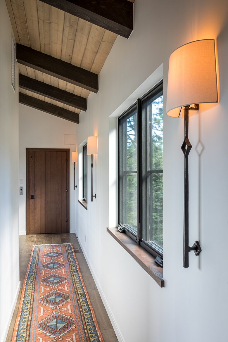 Upstairs hallway with windows and elevator door.