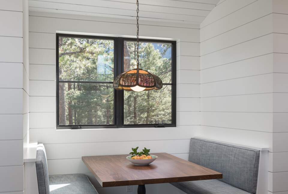 Booth seating with wood table built into shiplap walls