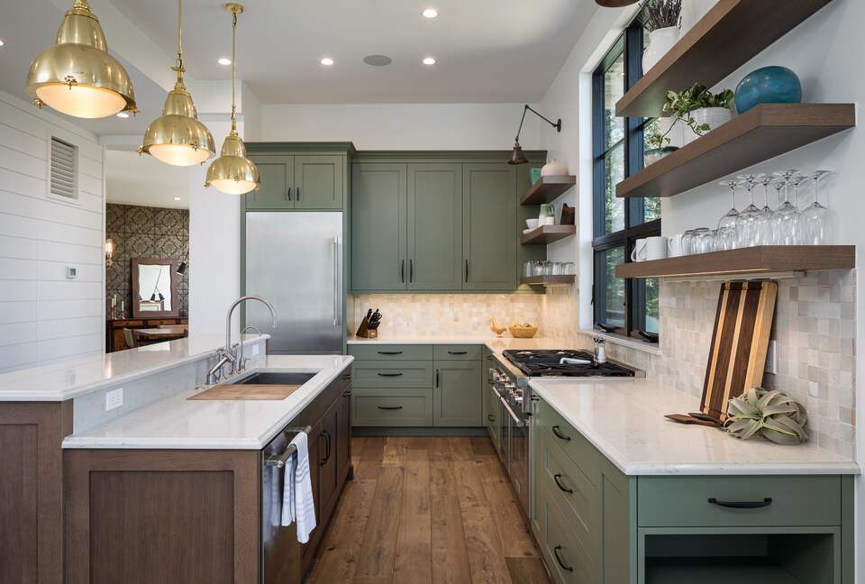 Full kitchen with white counters & sage & wood cabinetry
