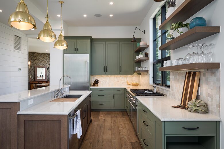 Full kitchen with white counters & sage & wood cabinetry