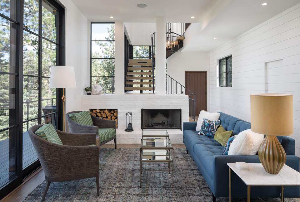 Living room with 10' sliding glass door, fireplace & sofa.