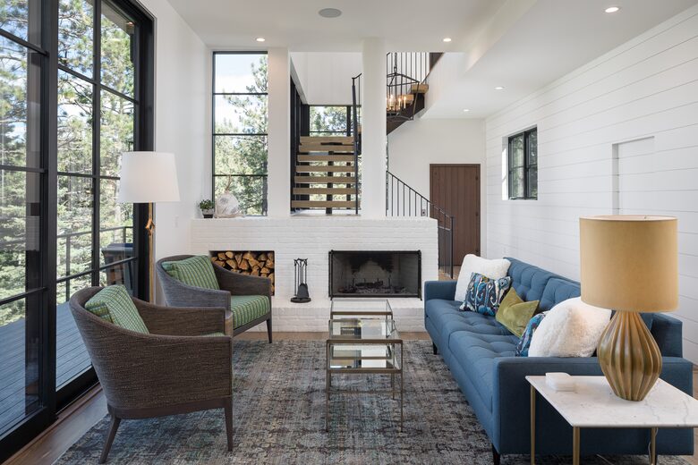 Living room with 10' sliding glass door, fireplace & sofa.