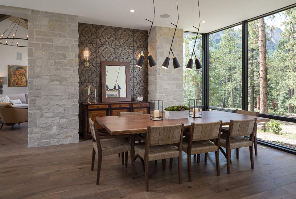Dining room with table & 8 chairs & floor to ceiling windows