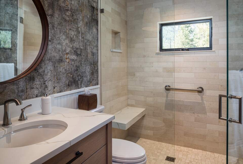 Guest room full bath with sink, toilet, and walk-in shower.