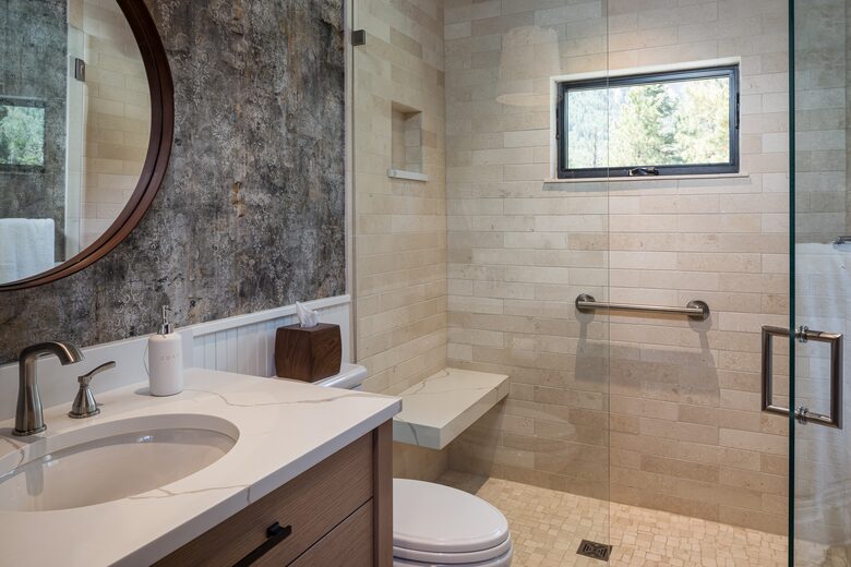 Guest room full bath with sink, toilet, and walk-in shower.