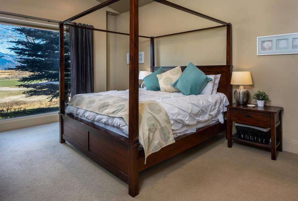 Main level master bedroom with king canopy, four-poster bed