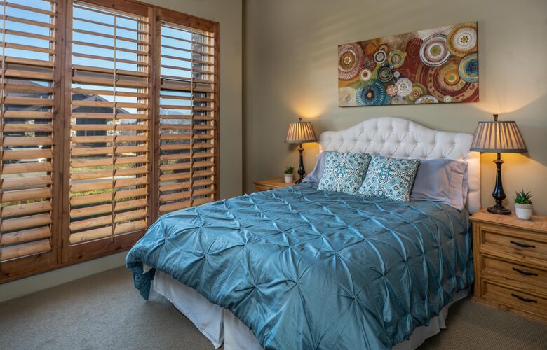 Guest room queen bed with cerulean blue comforter