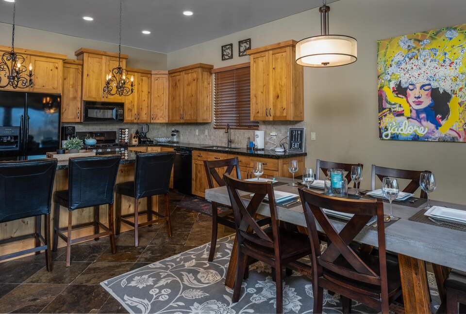Dining room with table and kitchen with island seating