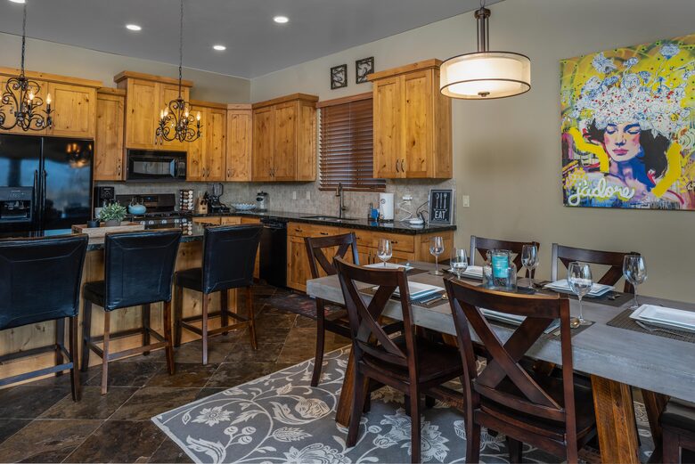 Dining room with table and kitchen with island seating
