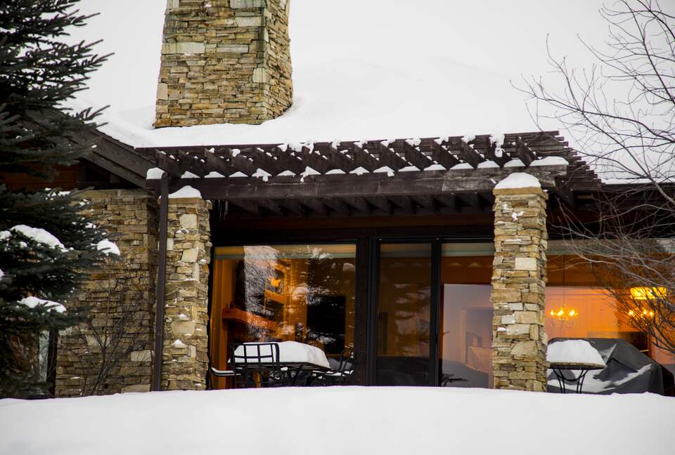 Exterior view of house and back patio covered in snow