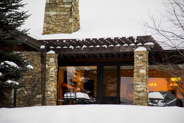 Exterior view of house and back patio covered in snow