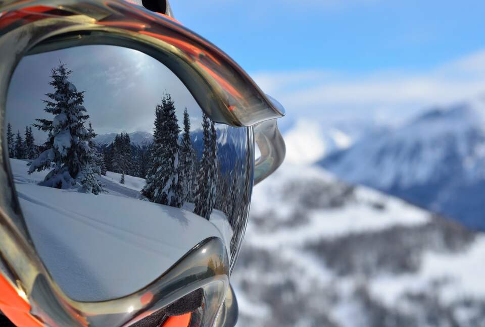 Mountain reflection in ski goggles on a sunny day