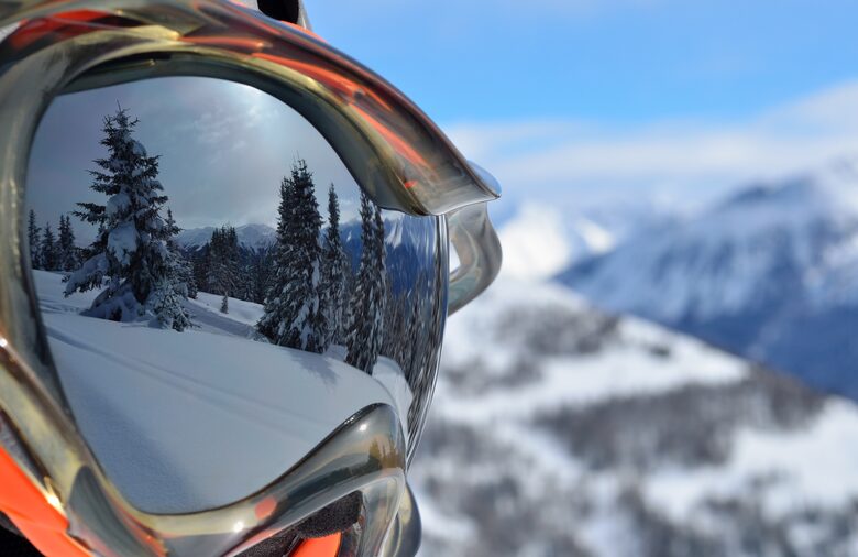 Mountain reflection in ski goggles on a sunny day