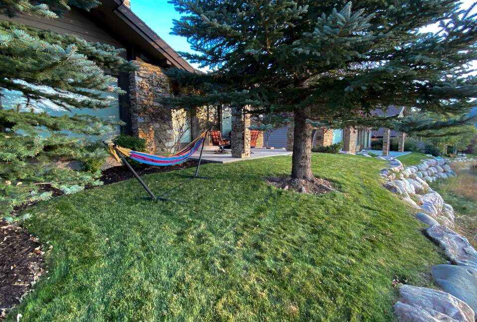 Hammock in the grass next to the house