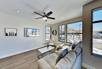 Main floor living room with beige sectional and wall art