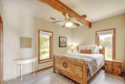 Guest room with queen bed and wood furniture