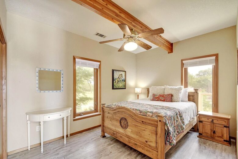 Guest room with queen bed and wood furniture