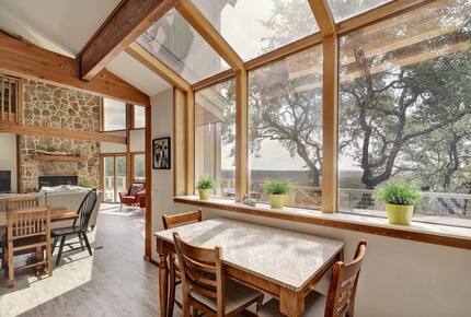 Lodge kitchen table with windows and Hill Country views
