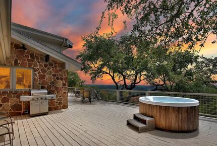 The Lodge deck with round hot tub at sunset