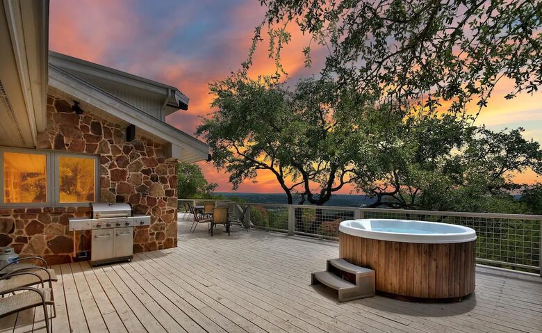The Lodge deck with round hot tub at sunset
