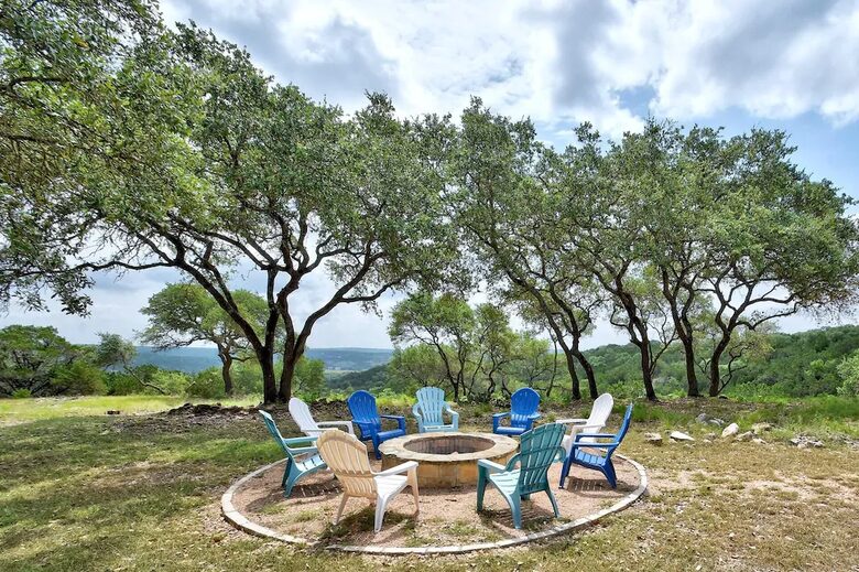 Fire pit with 9 Adirondack chairs overlooking Hill Country