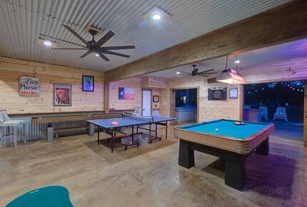 Retreat game room at night with ping pong & pool tables