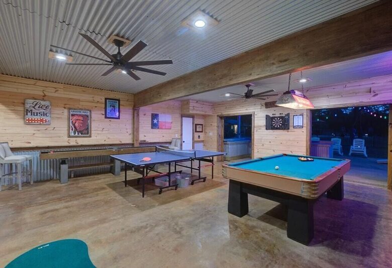 Retreat game room at night with ping pong & pool tables