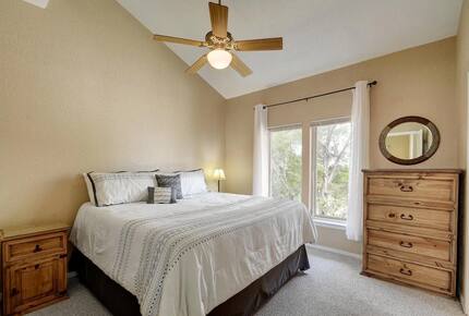 Upstairs bedroom in Retreat with king bed and wooden dresser