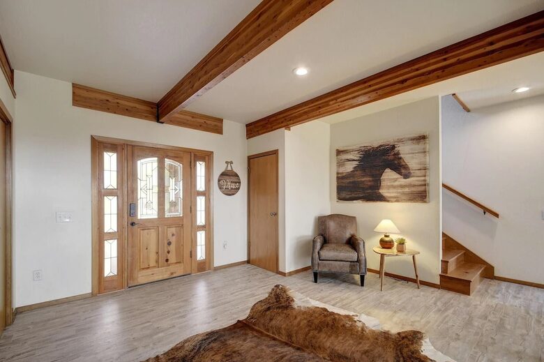 Interior entryway to the lodge with wood door & exposed beam