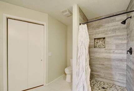 Toilet, closet & newly renovated shower upstairs in Retreat