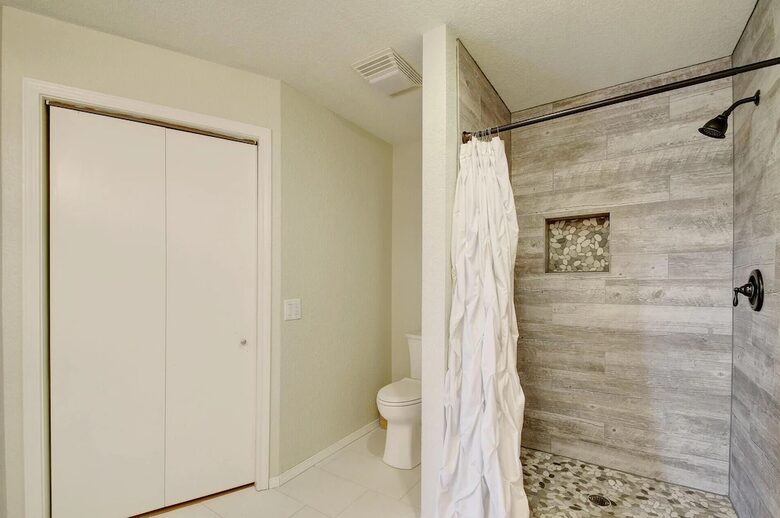 Toilet, closet & newly renovated shower upstairs in Retreat